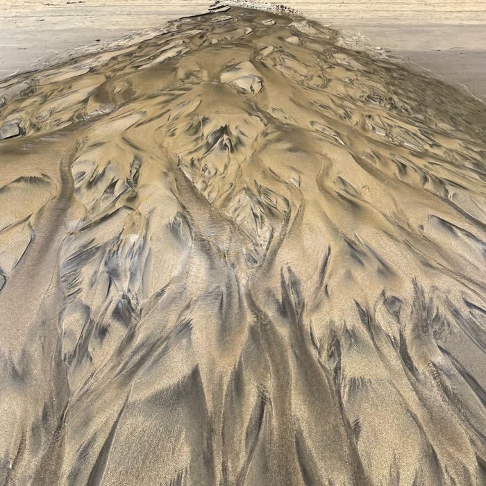 Stunning aerial view of intricate sand patterns in a desert landscape, showcasing natural artistry.